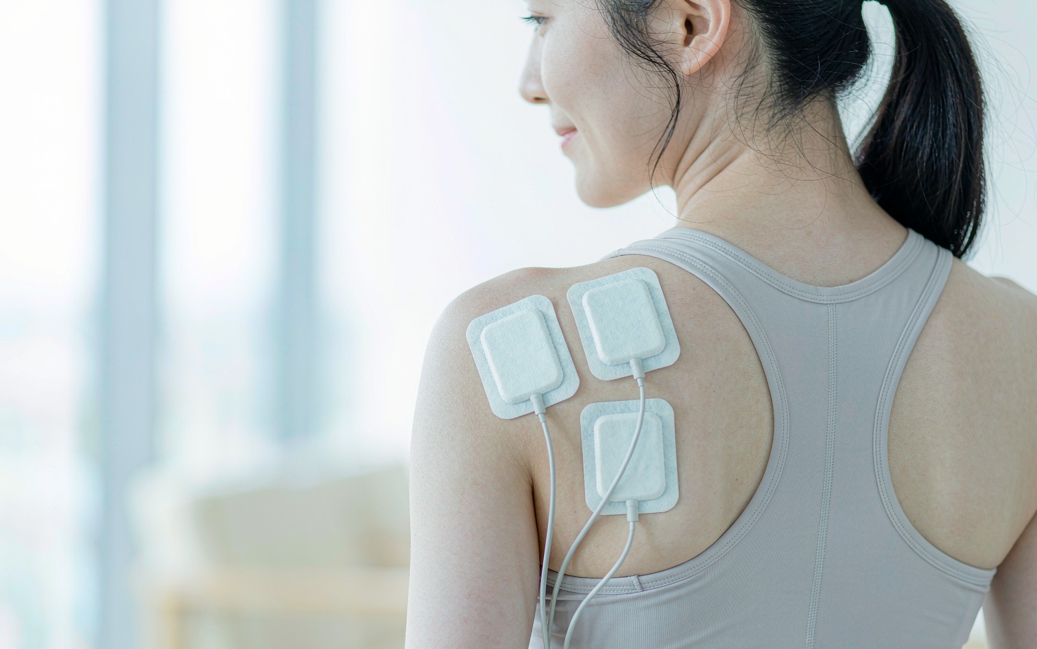 Medical electrode pads applied on a woman's back